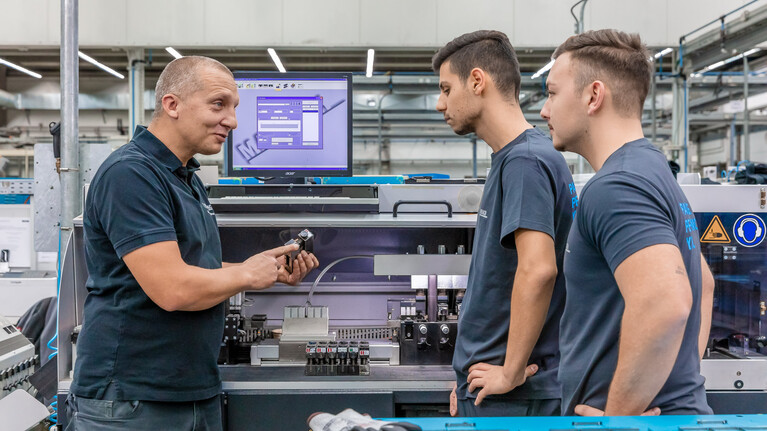 Trainer shows prospective packaging technologists at Marbach how to operate an automatic cutting and notching machine. | © Marbach Group
